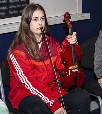 young woman in fiddle workshop