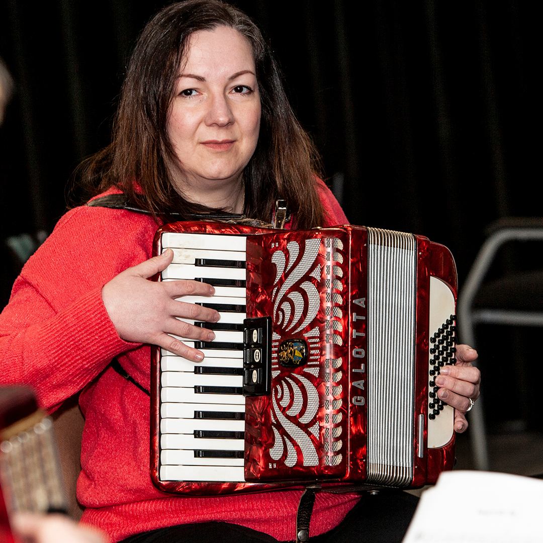 Adult playing accordion