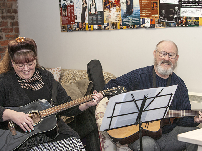 Guitar pupils smiling