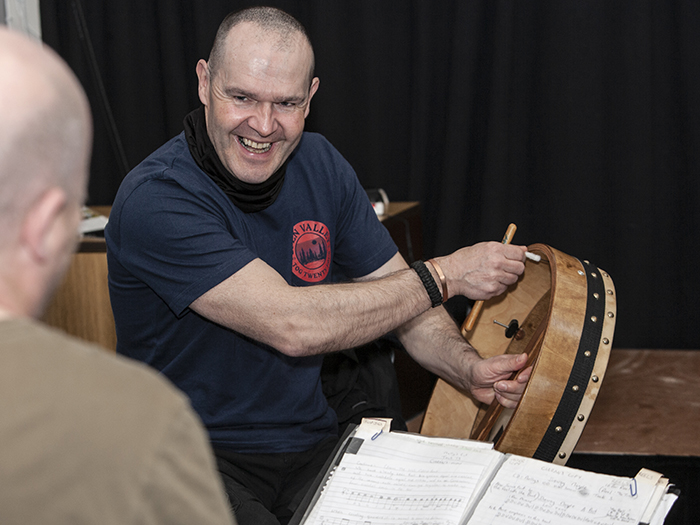 Tutor smiling during bodhran workshop