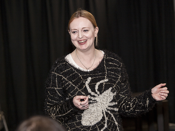 Folk song tutor smiling 